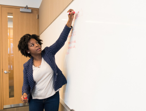 woman writing on whiteboard