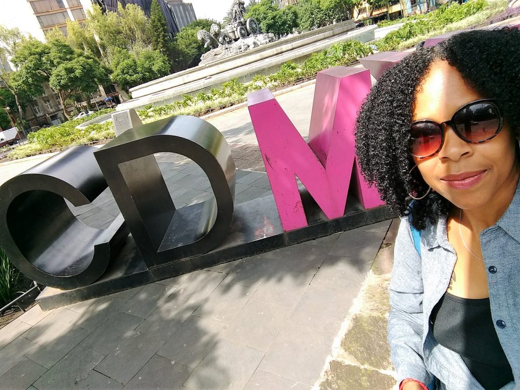 woman standing in front of CDMX sign