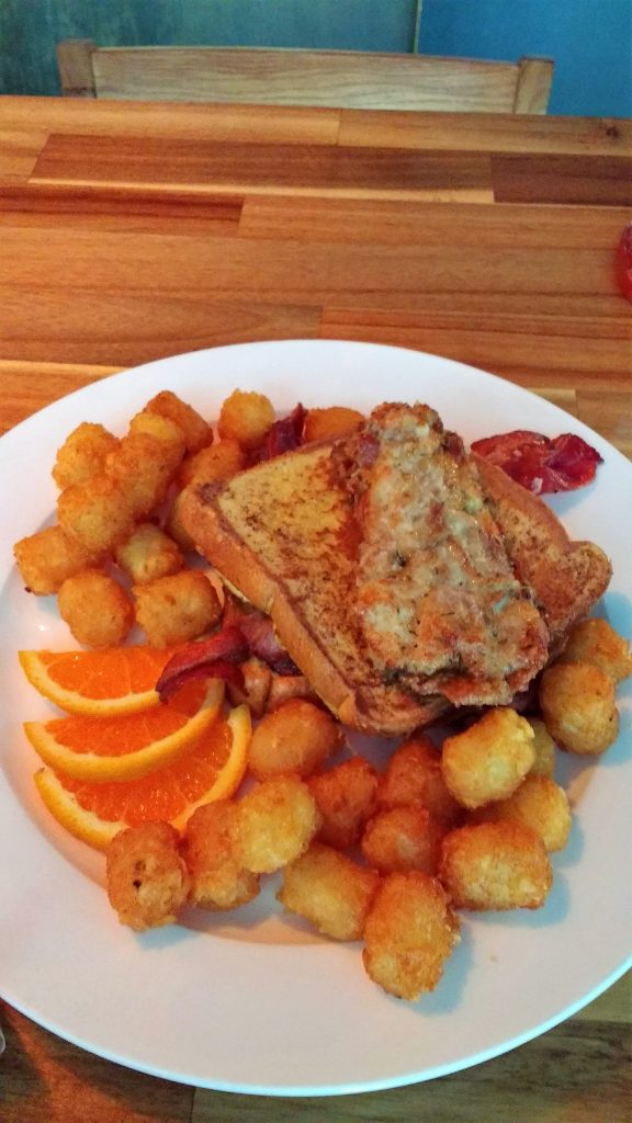 tater tots, orange slices, fried chicken, bacon and French toast